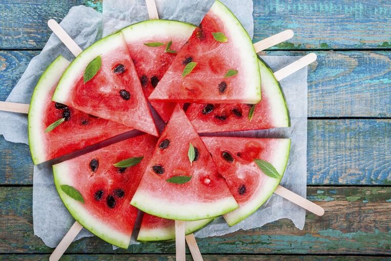 Slices of watermelon on a stem for a snack on a watermelon diet